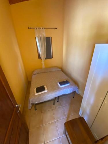 a small room with a bed in the corner of a room at B&B Biobonizio PIERLUIGI in Montegrosso