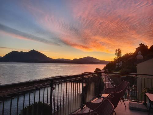 a balcony with a view of a body of water at Sempione Boutique Hotel in Stresa