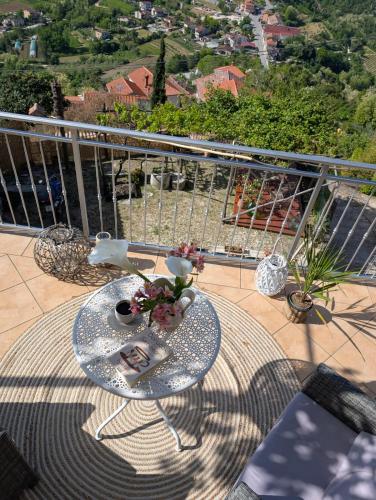 a table on a balcony with a view of a city at Studio apartman Bel Vedere in Motovun