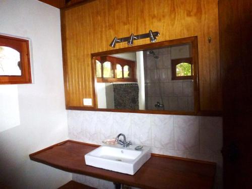 a bathroom with a sink and a mirror at Cabaña Oreko in Hanga Roa