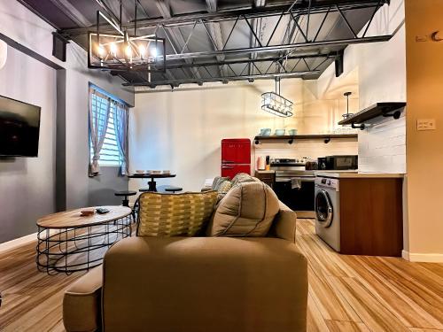 a living room with a couch and a kitchen at The Lofts At Santurce in San Juan