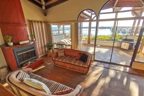 a living room with a couch and a fireplace at Playa Plateada Beach House in Ensenada