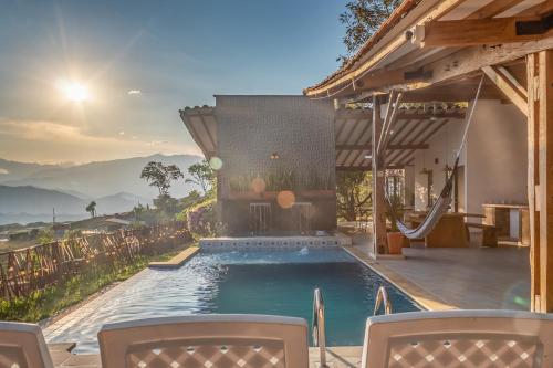 a swimming pool in a house with mountains in the background at Monteclaro Campestre - En Sopetran in Sopetran