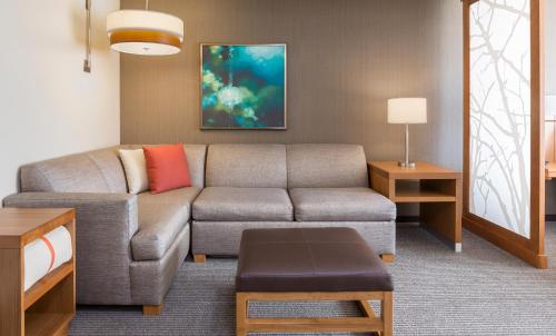 a living room with a couch and a table at Hyatt Place Canton in Lake Cable