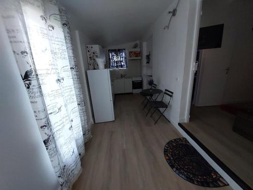 a hallway with a room with a table and a refrigerator at Love zen et spa in Solliès-Toucas