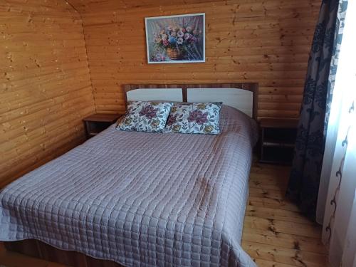 a bedroom with a bed in a wooden cabin at Casa Gherman in Turda