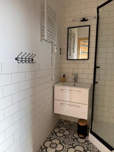 a bathroom with a sink and a mirror at Sunbella Sarbinowo in Sarbinowo