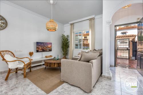a living room with a couch and a table at ViVi Homes - Casa Elola in Fuengirola