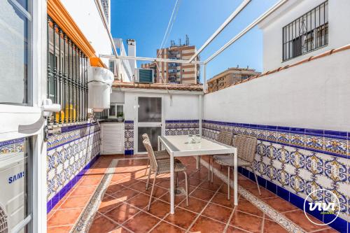 a balcony with a table and chairs in a building at ViVi Homes - Casa Elola in Fuengirola