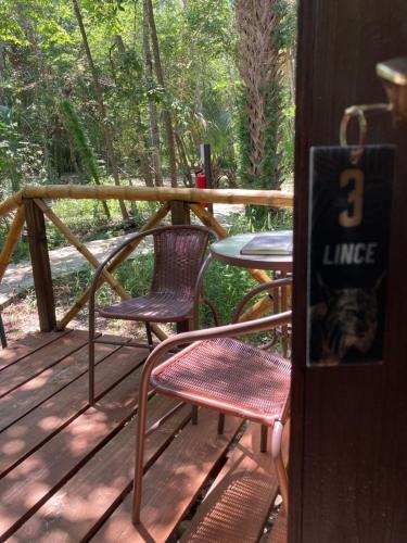 a porch with two chairs and a table with a number three sign at Selva Teenek Eco-Park in Ciudad Valles