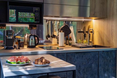 a kitchen with two plates of food on a counter at Water Hideout - Floating Luxury in Pure Wilderness in Wysoka