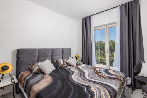 una camera da letto con un letto grande con una grande finestra di Vila Lux 2 a Fiume (Rijeka)
