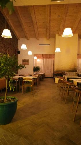 a large room with tables and chairs and lights at Kasollet e zanave in Pristina
