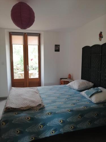 une chambre avec un lit avec une couette bleue dans l'établissement Etang et moulin, à La Celle-sous-Gouzon