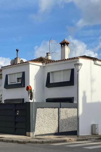 a white house with a gate and a fence at Jerez Deluxe in Jerez de la Frontera