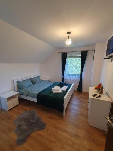a bedroom with a bed with a green comforter at Cabana Gap House in Colţeşti