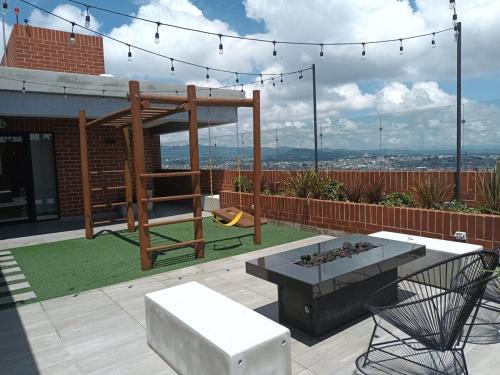 a patio with a fire pit and a playground at Executive Studio Apartment Zone 10 with Parking in Estación Pamplona