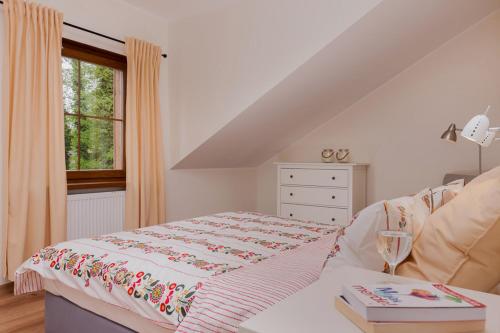 a white bedroom with a bed and a window at APARTAMENTY STARE SARBINOWO in Sarbinowo