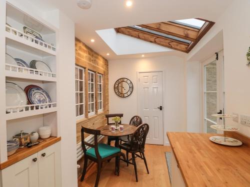 a kitchen and dining room with a table and chairs at Two Towers Cottage in Montacute