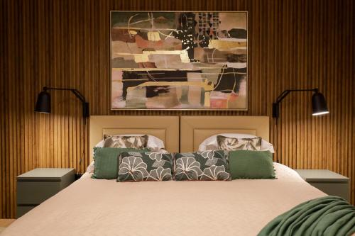 a bedroom with a bed with two pillows on it at Dabney3 Apartments in Madalena