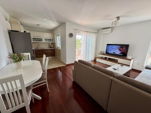 a living room with a couch and a table at Apartment on the beach Mare in Makarska