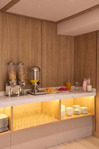 a kitchen with a counter with a mixer and plates at Hotel Lincoln in Medellín