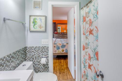 a bathroom with a toilet and a sink and a shower at Walk to Beach and Barefoot Landing Resort Condo! in Myrtle Beach