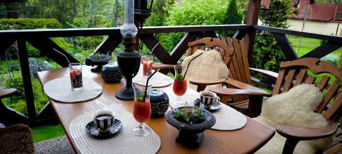 a wooden table with plates and glasses on it at Na Divokom Vŕšku in Jamník