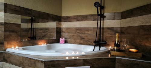 a bathroom with a tub with candles in it at Na Divokom Vŕšku in Jamník