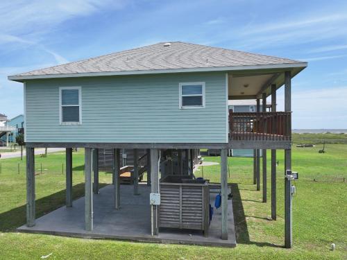 a house on a porch with a deck at KCs Sunshine by Bolivar Escapes in Crystal Beach