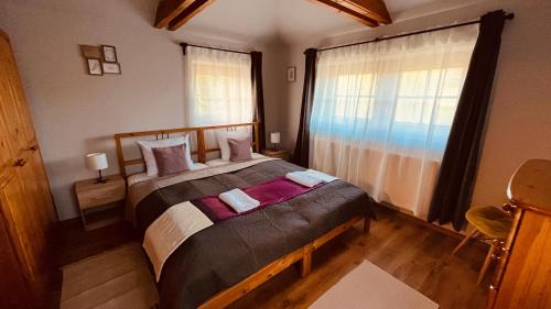 A bed or beds in a room at Strigonia Apartman