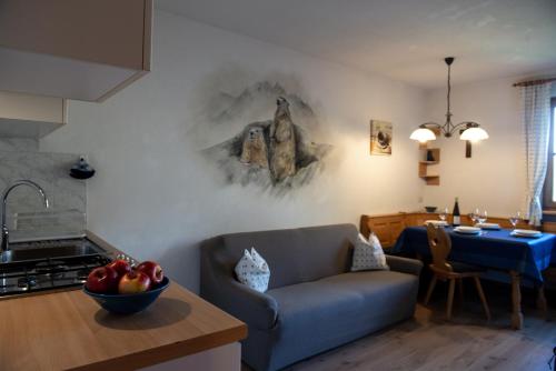 a kitchen and living room with a couch and a table at Im Kranzhof in San Candido