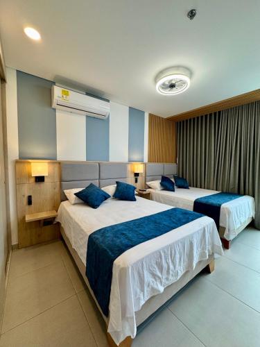 Postel nebo postele na pokoji v ubytování Lujosa Apartasuite en Santa Marta