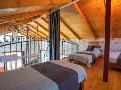 a bedroom with two beds in a room with wooden ceilings at Sora no mori in Marmaris