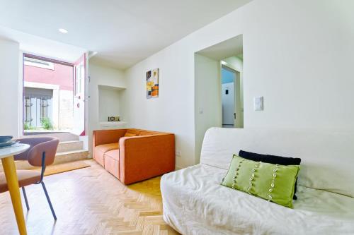 a small bedroom with a bed and a couch at New flat and central in Lisbon