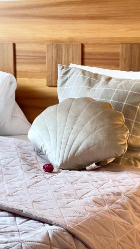 a bed with white sheets and pillows on it at Gästezimmer Karolina in Dölsach