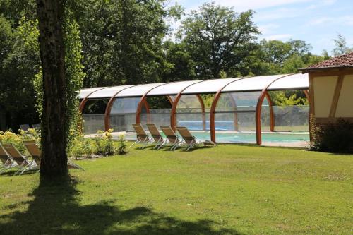 un groupe de chaises assises à côté d'une piscine dans l'établissement La maison Séquoia, à Gien