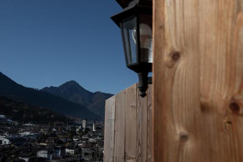 a light on a building with a view of a city at Im Kranzhof in San Candido