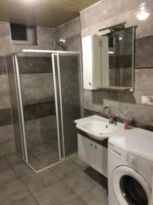 a bathroom with a shower and a toilet and a sink at VB Otel in Kumartaş