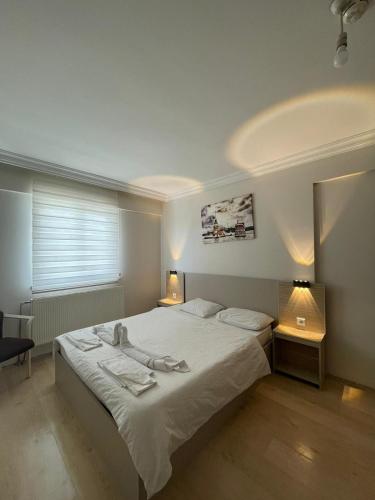 a bedroom with a bed with two towels on it at VB Otel in Kumartaş