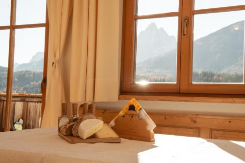 a room with a table with a view of a mountain at Im Kranzhof in San Candido