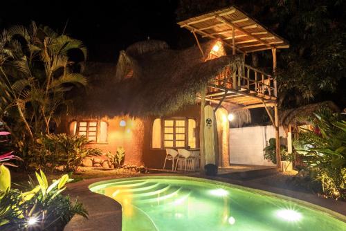 a house with a swimming pool at night at El Manguito in Sayulita