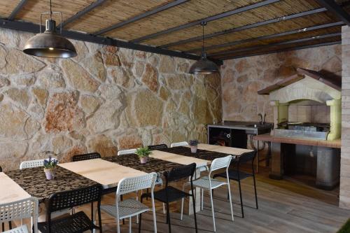 a restaurant with tables and chairs and a stone wall at וילה גליתא - בריכה , ג'קוזי ונוף in ‘Ein Ya‘aqov