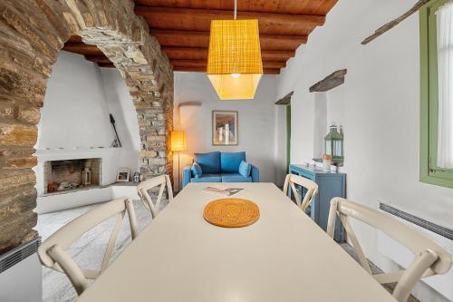 a kitchen and dining room with a table and chairs at Sea view house , for 5 persons in Triandaros in Triandáros