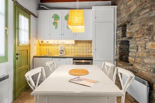 a kitchen with a white table and white chairs at Sea view house , for 5 persons in Triandaros in Triandáros