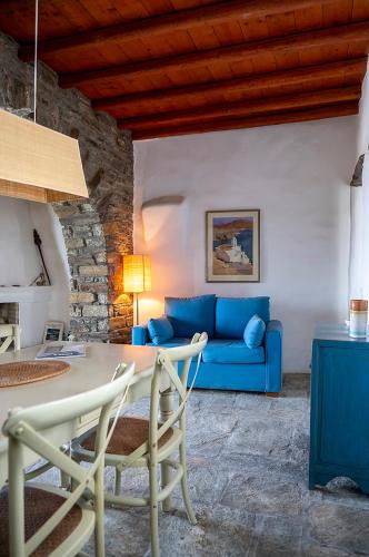a living room with a blue couch and a table at Sea view house , for 5 persons in Triandaros in Triandáros