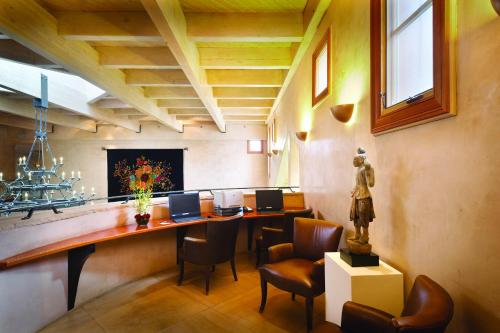 a room with two desks with chairs and a statue at El Monte Sagrado Resort & Spa in Taos