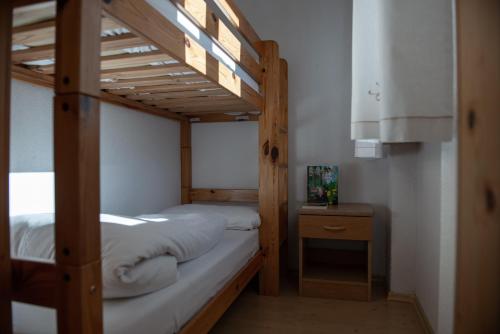 a bedroom with two bunk beds and a night stand at Im Kranzhof in San Candido