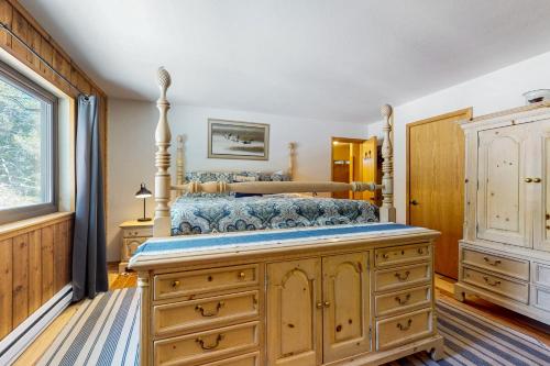 a bedroom with a bed with a wooden dresser at Tastefully-Updated, Classic Tahoe Family Home in Truckee