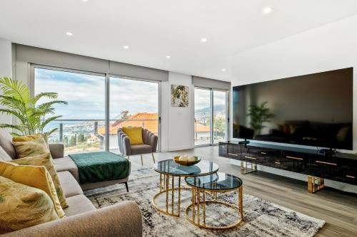 a living room with a couch and a table at Villa Vellure by Homie in Funchal